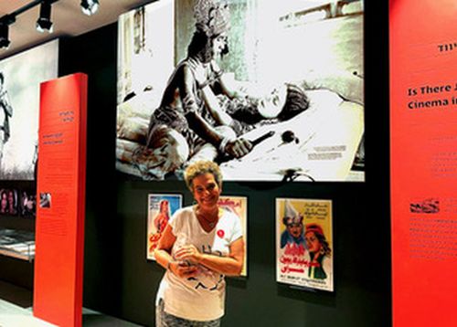 Rachel in front of her grandmother's movie poster